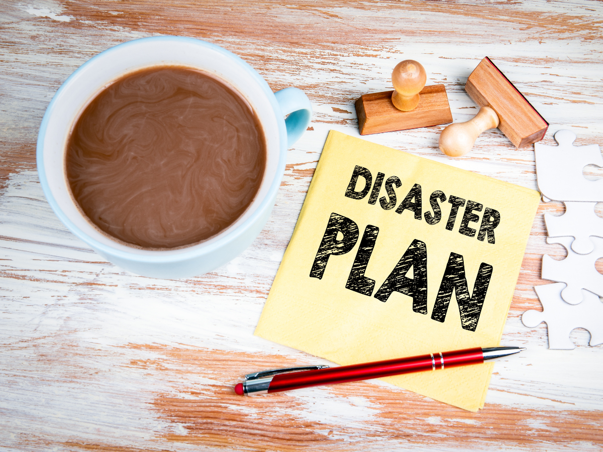 A photo of a table with a sticky note that says "Disaster Plan"