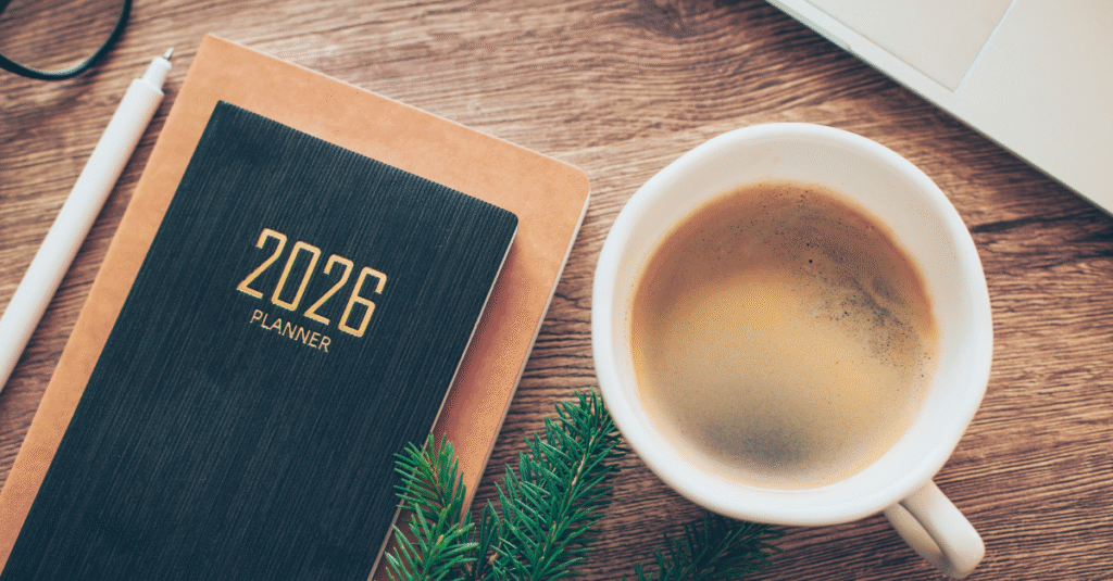 A desk with a planner that says 2026 and a coffee.